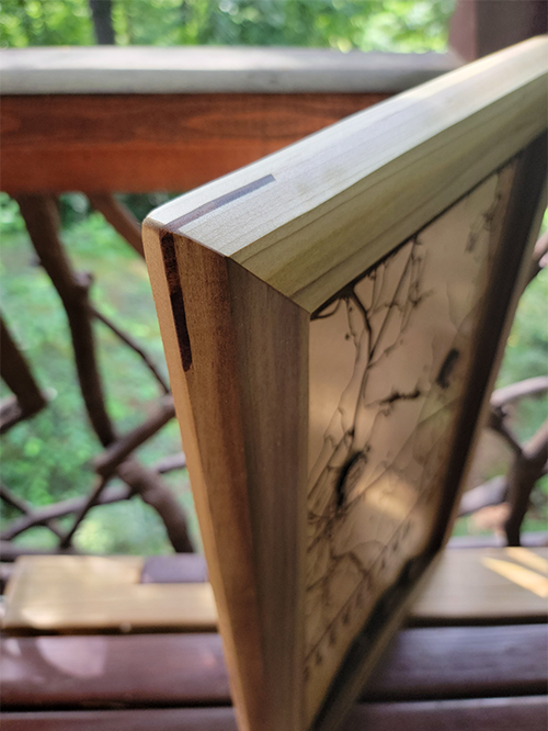 Close up of the walnut splines in the map frame of a custom location map from G. Loebick Woodworks