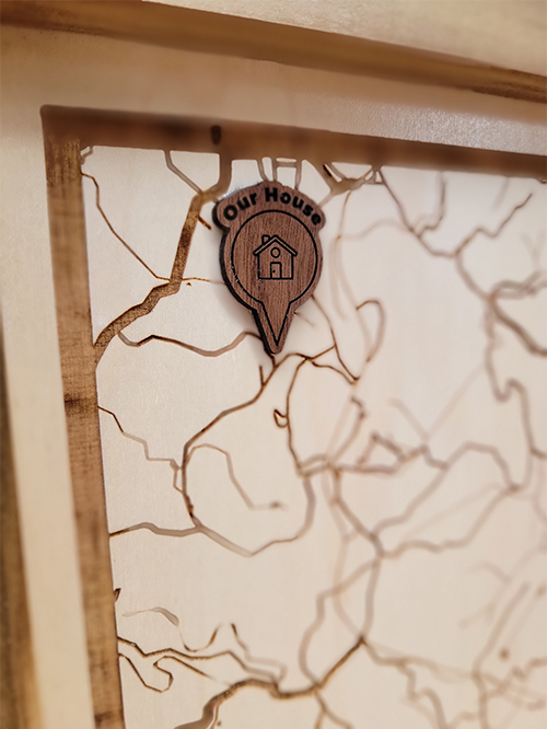 A personalized location icon that reads "Our House" on a custom location map from G. Loebick Woodworks