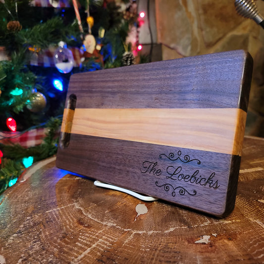 Two-toned, personalized wooden cutting board.